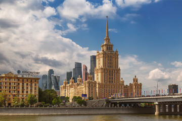 View of Moscow on a sunny summer day with the building of the Radisson Collection hotel (Ukraine) and the Novoarbatsky bridge across the Moscow river, Russia