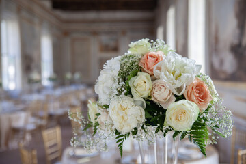 hall of an ancient castle with catering for catering and wedding events. Detail of floral bouquet on table