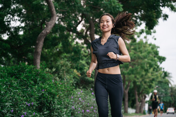 Happy beautiful girl exercise jogging with tree background	