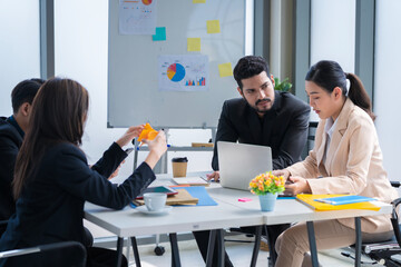 A group of young businessmen in Asian suits are passionate and excited about their work. And to encourage team members and have a commitment to accomplish the assigned tasks professionally.