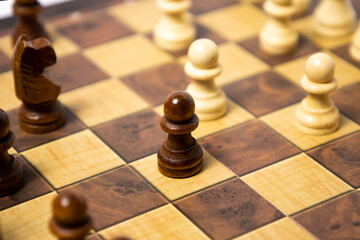 Wooden chess pieces are arranged on a wooden board. Business strategy concept.