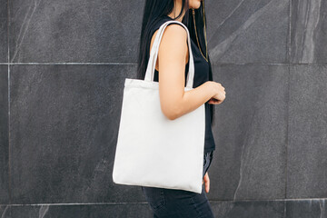 Young asian model  girl on the street holding white eco bag, mock up
