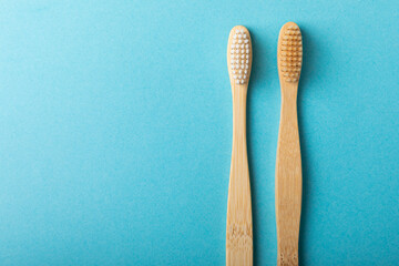 Eco-friendly bamboo toothbrush on a blue background. The concept of cosmetic products for the...