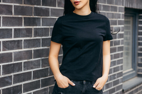 Stylish brunette asian girl wearing black t-shirt posing against street , urban clothing style. Street photography