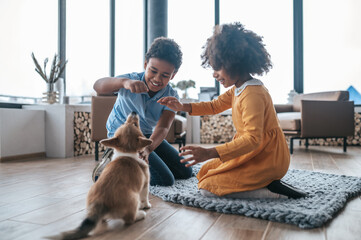 Kids training the puppy and looking excited
