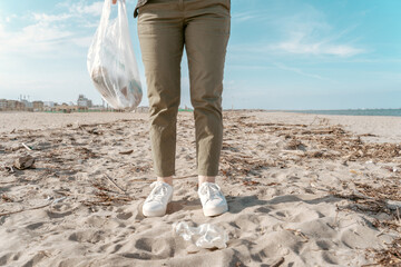 Environmental activist gathering garbage on the seashore