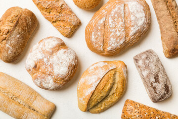 Homemade natural breads. Different kinds of fresh bread as background, top view with copy space