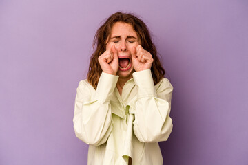 Young caucasian woman isolated on purple background whining and crying disconsolately.