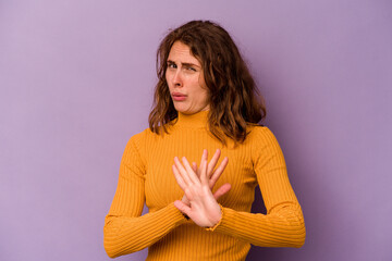 Young caucasian woman isolated on purple background doing a denial gesture