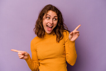 Young caucasian woman isolated on purple background pointing to different copy spaces, choosing one...