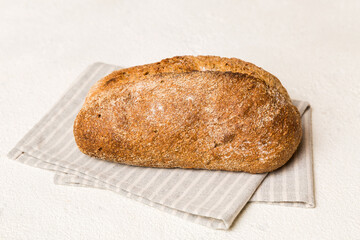 Assortment of freshly baked bread with napkin on rustic table top view. Healthy unleavened bread. French bread