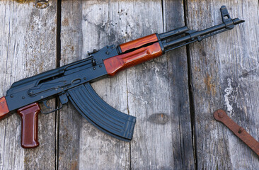The famous Soviet assault rifle on an old, damaged board