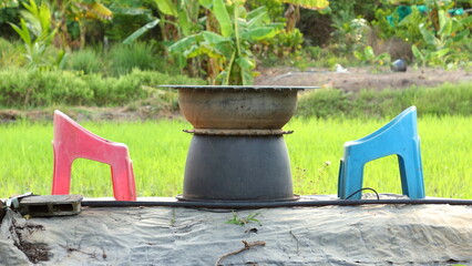 table and chairs on rice field background