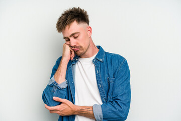 Young caucasian man isolated on white background who feels sad and pensive, looking at copy space.