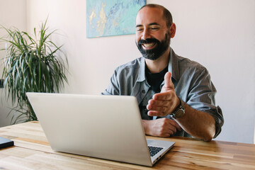 Young guy working at home, making a videoconference