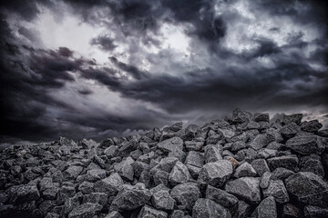 Granite stone under stormy clouds