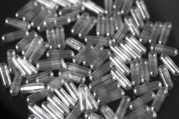 Blank Transparent Capsules on a Black Background