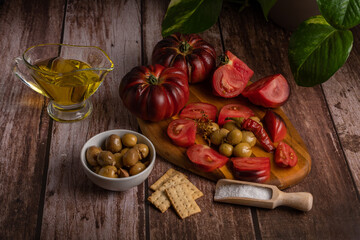organic moorish tomatoes with oil, salt and olives, mediterranean diet