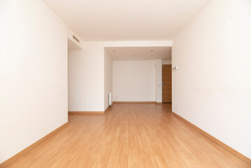 Empty living room with light wood flooring, ducted air conditioning and halogen ceiling lights
