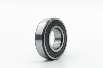 Closed type bearing for modern equipment and machines on a white background. Italian ball bearing with protective covers. Selective focus