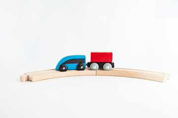 Toy wooden steam locomotive transports goods by rail