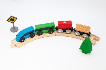 Obraz premium Toy wooden steam locomotive transports goods by rail