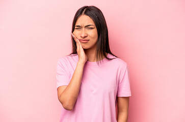 Young hispanic woman isolated on pink background having a strong teeth pain, molar ache.