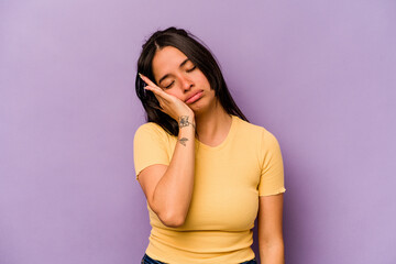 Young hispanic woman isolated on purple background who is bored, fatigued and need a relax day.