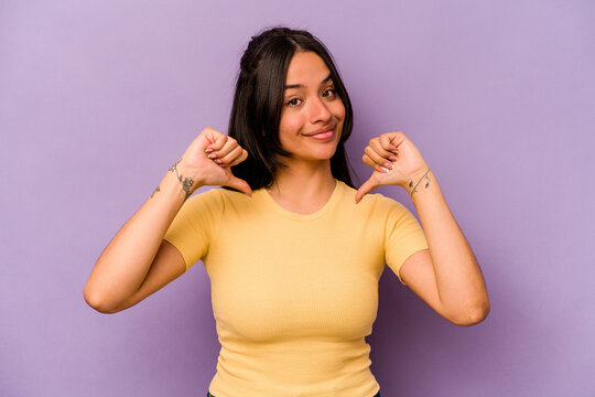Young hispanic woman isolated on purple background feels proud and self confident, example to follow.