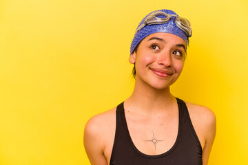 Young swimmer hispanic woman isolated on yellow background
