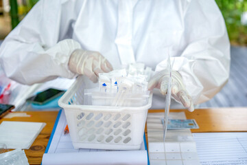 Medical Staff is preparing equipment to collect sample test for people who involve COVID test.