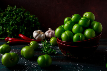 Tkemali, green cherry plum, with ingredients for sauce, on a wooden table, close-up, rustic, food background, no people, selective focus,