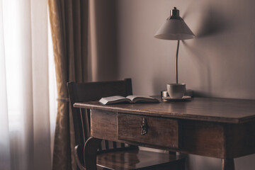 antique table in a dark room with a lamp