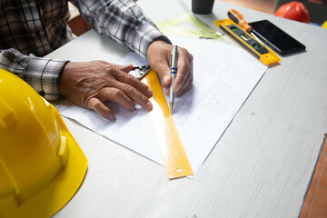 Old Engineer and Architect drawings blueprint  at Construction Site  