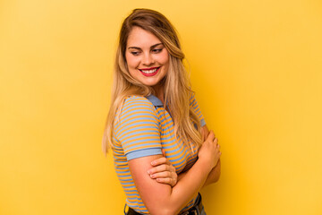 Young caucasian woman isolated on yellow background laughing and having fun.