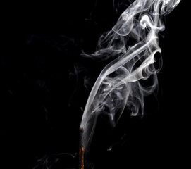 Match with smoke. Smoke coming from a half-burnt match on a black background close-up.