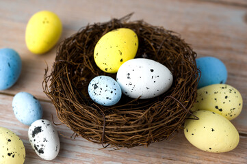 Closeup of white,yellow and blue eggs in th nest Happy easter banner