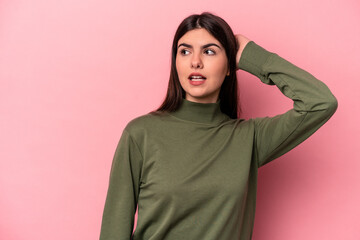 Young caucasian woman isolated on pink background being shocked, she has remembered important...