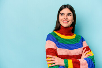 Fototapeta premium Young caucasian woman isolated on blue background smiling confident with crossed arms.
