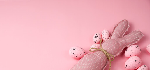 Monochrome pink easter banner with toy bunnies and eggs. Place for text