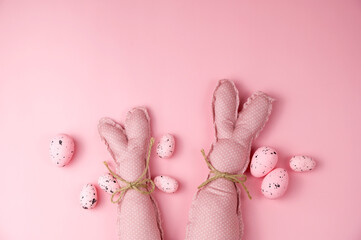 Fototapeta na wymiar Pink toy bunnies on pink background .Flat lay banner.Happy easter banner.