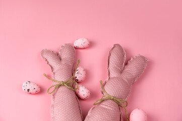 Pink toy bunnies on pink background .Easter banner. Greetings card