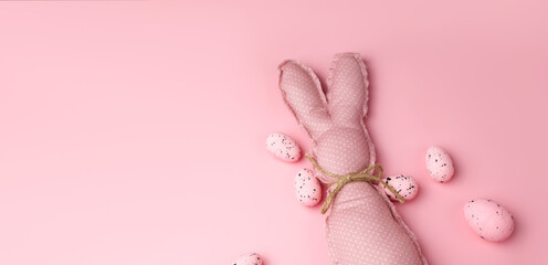 Monochrome pink easter banner with toy bunnies and eggs. Place for text