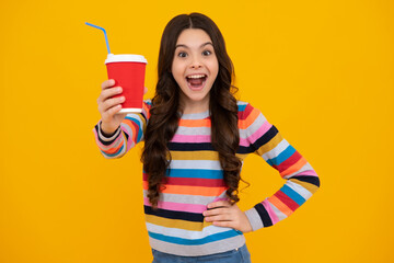 Teenager child with coffee cup isolated on yellow studio background. Girl drinking take away beverage. Amazed teenager. Excited teen girl.