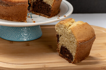 Marble cake on a plate, one slice taken out, homemade