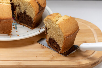 Marble cake on a plate, one slice taken out, homemade