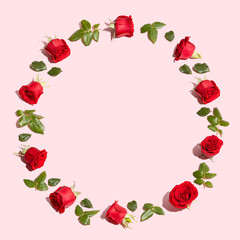 Creative flowers composition. Vintage frame made of red roses on pastel pink background. Minimal flat lay. Valentine's Day or love concept.