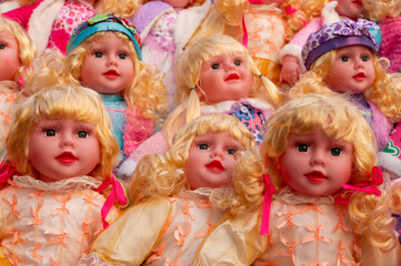 Beautiful cute blonde baby dolls for sale at retail shop at Christmas market, New Market area, Kolkata, West Bengal, India.