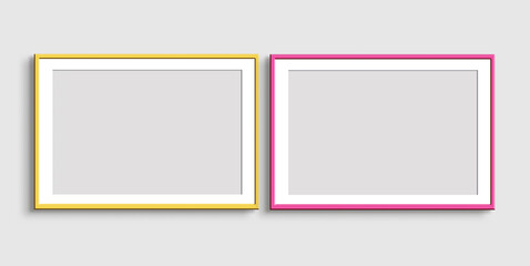 Fototapeta na wymiar Two horizontal yellow and pink frames on a light gray background. Mockup of poster frames. Art show.