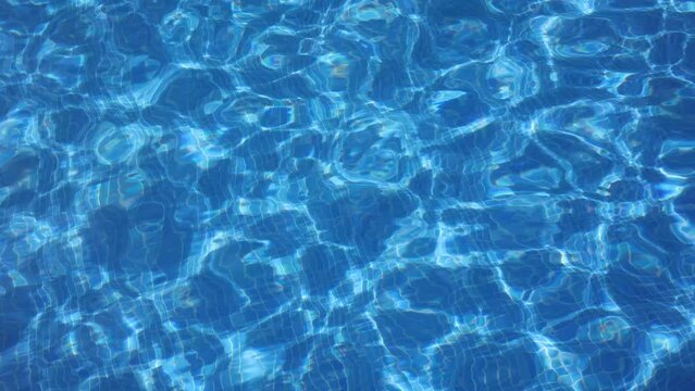 background of rippled pattern of clean water in blue swimming pool